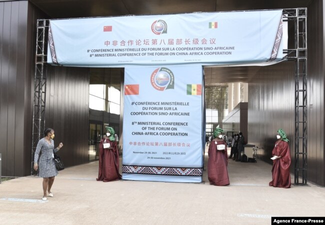 FILE - Senegalese delegates enter the conference hall during the China-Africa Cooperation (FOCAC) meeting at the Diamniadio in Dakar, Senegal, Nov. 29, 2021.