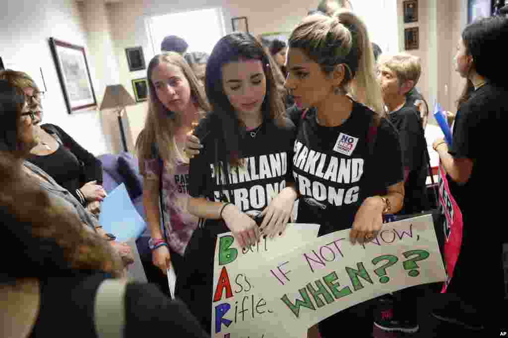 Lital Donner, youth director for Congregation Kol Tikvah, comforts Aria Siccone, 14, a 9th grade student survivor from Marjory Stoneman Douglas High School, where over a dozen were killed in a mass shooting on Wednesday.