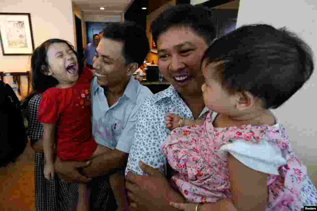 Reuters reporters Wa Lone and Kyaw Soe Oo celebrate with their children after being freed by presidential pardon from prison in Yangon, Mayanmar. The government had jailed the journalists for more than 500 days in connection with their reporting on the Rohingya crisis.