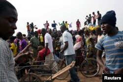 FILE - People sell clothes at the displaced camp at Mpoko international airport in Bangui, Central African Republic, Feb. 26, 2014.