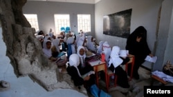 Girls attend a class at their school damaged by a recent Saudi-led air strike, in the Red Sea port city of Hodeidah, Yemen, Oct. 24, 2017.
