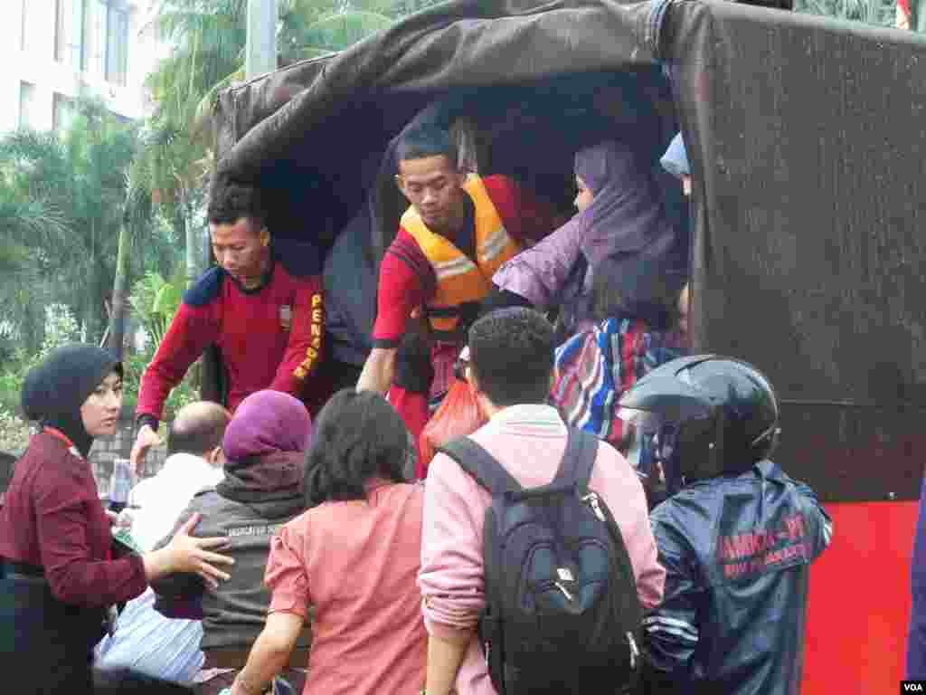 People board a jeep on a flooded street, Jakarta, Indonesia, January 17, 2013. (VOA Indonesian Service)