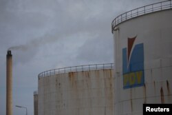 The logo of the Venezuelan oil company PDVSA is seen on a tank at Isla refinery in Willemstad on the island of Curacao, April 22, 2018.