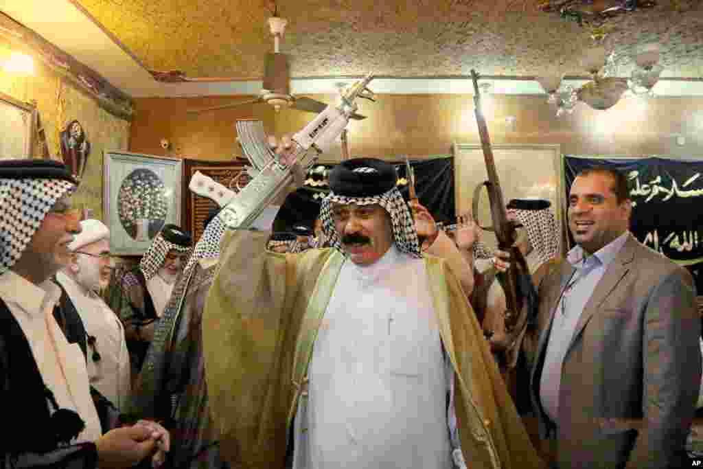 Iraqi Shiite tribal leaders chant slogans against the al-Qaida-inspired Islamic State of Iraq and the Levant (ISIL), in Baghdad, June. 13, 2014.&nbsp;