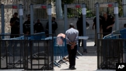 A Palestinian man walks towards a metal detector at the Al Aqsa Mosque compound in Jerusalem's Old City, July 19, 2017. A dispute over metal detectors has escalated into a new showdown between Israel and the Muslim world.