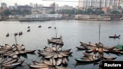 Boats are seen anchored by the river Buriganga, on the outskirts of Dhaka May 19, 2014.