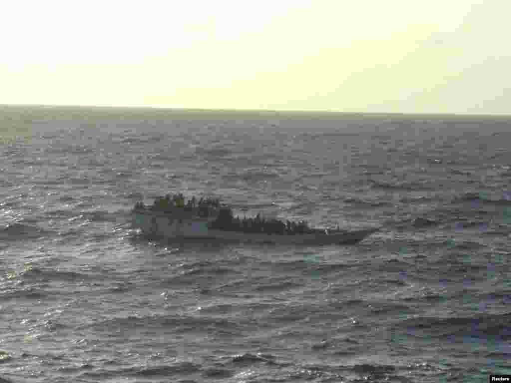 This boat, carrying about 150 suspected asylum seekers capsized June 27, 2012 between Indonesia and Australia&#39;s Christmas Island in the India Ocean, the second such incident in less than a week, highlighting Australia&#39;s struggle to stem the flow of boat people. 