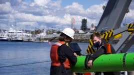 In this March 2021 image provided by Scripps Institution of Oceanography at UC San Diego, researchers aboard the research vessel Sally Ride recover a robtic underwater vehicle off the coast of Southern California. (Scripps Institution of Oceanography at UC San Diego via AP)