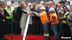 Turkey's Prime Minister Tayyip Erdogan (3rd L), his wife Emine Erdogan (4th L), President Abdullah Gul (6th L) and his wife Hayrunnisa Gul (5th L) attend a groundbreaking ceremony for the third Bosphorus bridge linking the European and Asian sides of Ista