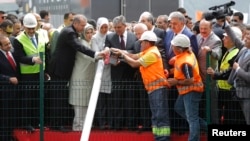 PM Erdogan (3rd L), his wife Emine (4th L), President Abdullah Gul (6th L) and his wife (5th L) attend a groundbreaking ceremony for the third Bosphorus bridge, May 20, 2013.