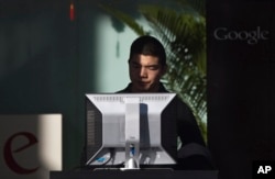 FILE - A man uses computer at the guests waiting area inside Google China's headquarters building in Beijing, China on Jan. 25, 2010.