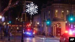 Policías recorren las calles del centro de Waukesha, Wisconsin, el domingo 21 de noviembre de 2021, luego de que una camioneta embistió un desfile navideño. 