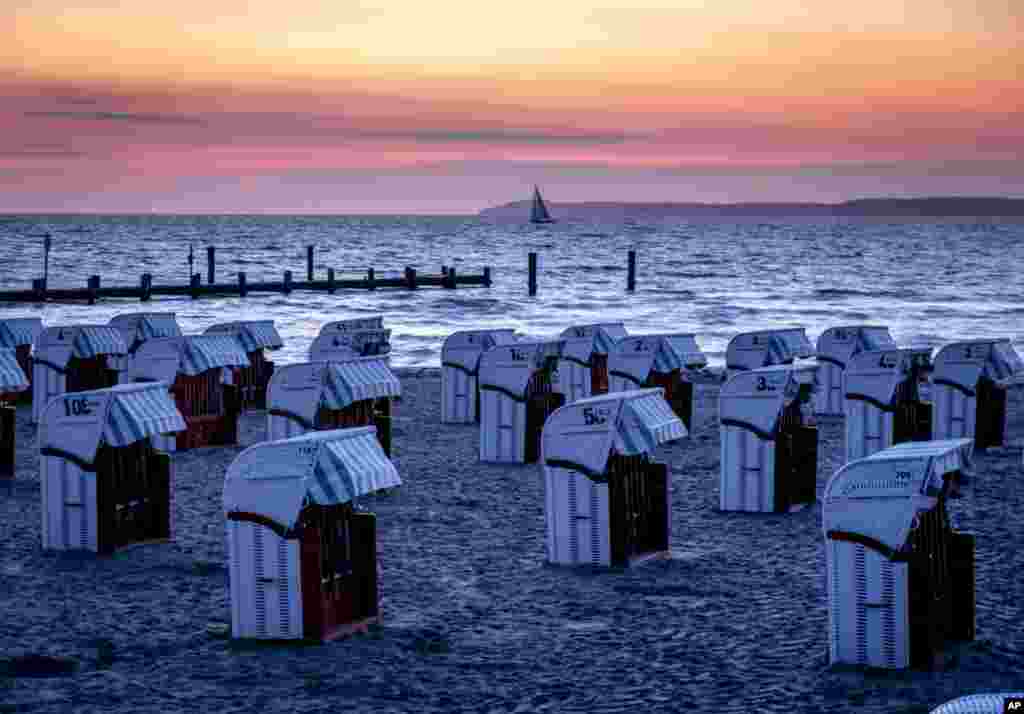 Beach chairs are lined up at the Baltic Sea before sunrise in Travemuende, northern Germany.