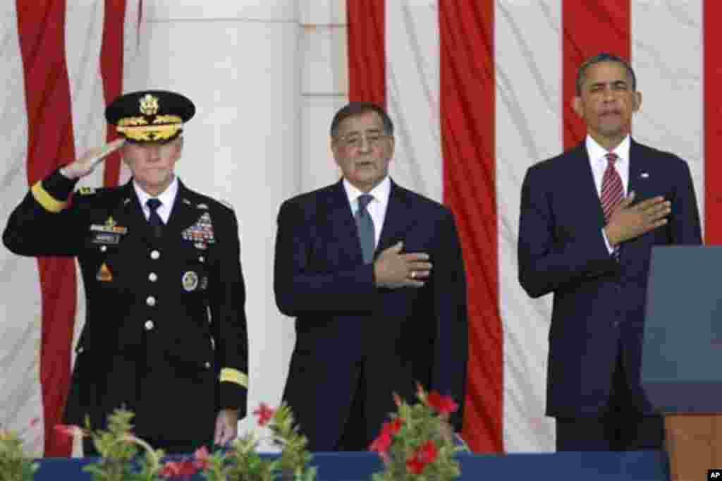 President Barack Obama, right, Defense Secretary Leon Panetta, center, and Chairman of the Joint Chiefs of Staff Gen. Martin Dempsey, stand during the singing of the National Anthem at the Memorial Day Observance at the Memorial Amphitheater at Arlington