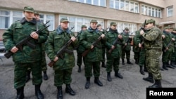 Members of a pro-Russian self-defense unit stand in formation as they ready to swear an oath to the pro-Russia Crimea regional government in Simferopol, March 13, 2014.