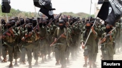 New recruits belonging to Somalia's al-Qaeda-linked al Shabaab rebel group march during a passing out parade at a military training base in Afgoye, west of the capital Mogadishu February 17, 2011.