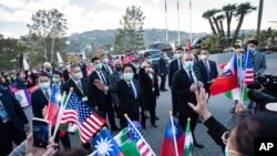 In this photo released by the Taiwan Presidential Office, Taiwan Vice President William Lai waves to supporters during a stopover in Los Angeles, Jan. 25, 2022. Lai is leading a Taiwanese delegation to Honduras for the inauguration of President-elect Xiomara Castro Jan. 27-28.