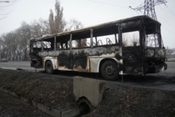A bus, which was burned during clashes, is seen on a street in Almaty, Kazakhstan, Jan. 9, 2022. (Vladimir Tretyakov/NUR.KZ via AP)