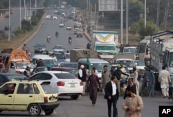 Supporters of a Pakistani religious group block a main road after a court decision in Islamabad, Pakistan, Oct. 31, 2018.