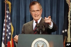 FILE - President George H.W. Bush acknowledges a reporter during a news conference at the White House, Dec. 5, 1991.