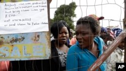 FILE - Women fleeing attacks on immigrants line up for food at a temporary refugee camp in east of Johannesburg, South Africa, Apr. 20, 2015. 