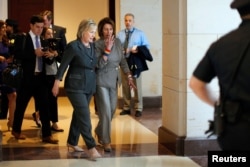 Democratic U.S. presidential candidate Hillary Clinton, left, and House Minority Leader Nancy Pelosi, a California Democrat, leave a House Democratic Caucus meeting on Capitol Hill in Washington, June 22, 2016.