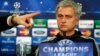 Chelsea's manager Jose Mourinho looks on as the press officer points to a member of the media during a press conference at Stamford Bridge in London, Monday, March 17, 2014. Galatasaray will play Chelsea on Tuesday in their Champions League round of 16 se