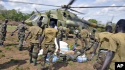 Ugandan soldiers, who are tracking down Lord's Resistance Army (LRA) fugitive leaders, load supplies from a military helicopter in a forest bordering Central African Republic, South Sudan and Democratic Republic of Congo, near river Chinko, April 18, 2012.