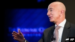FILE- In this Sept. 13, 2018, file photo Jeff Bezos, Amazon founder and CEO, speaks at The Economic Club of Washington's Milestone Celebration in Washington.