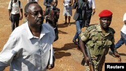 sejussa escorted by army officers in Kampala, Uganda