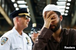 A man cries as community members protest hate crime after the funeral service of Imam Maulama Akonjee and Thara Uddin in the Queens borough of New York City, New York, Aug. 15, 2016.