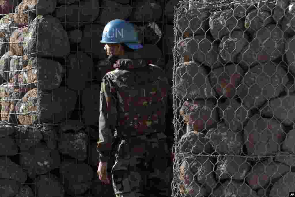 A U.N. soldier stands next to a shelter inside a UN base near the Quneitra crossing between Israel and Syria, June 7, 2013. 