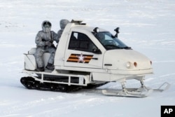 In this photo taken on April 3, 2019, a Russian military snowmobile travels across Kotelny Island, part of the New Siberian Islands archipelago located between the Laptev Sea and the East Siberian Sea, Russia.
