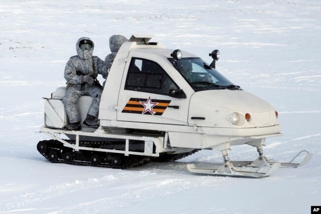 In this photo taken on April 3, 2019, a Russian military snowmobile travels across Kotelny Island, part of the New Siberian Islands archipelago located between the Laptev Sea and the East Siberian Sea, Russia.