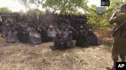 FILE - This file photo taken from video by Nigeria's Boko Haram terrorist network, May 12, 2014, shows the missing girls alleged to be abducted April 14, from the northeastern town of Chibok.