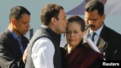Rahul Gandhi, newly elected president of India's main opposition Congress Party, kisses the forehead of his mother and leader of the party, Sonia Gandhi, after taking charge as the president during a ceremony at the party's headquarters in New Delhi, Indi