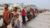 FILE - Rohingya refugees headed to the Bhasan Char island prepare to board navy vessels from the south eastern port city of Chattogram, Bangladesh. 