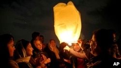 Iranians release a lit lantern during a celebration, known as "Chaharshanbe Souri," or Wednesday Feast, March 19, 2019, marking the eve of the last Wednesday of the solar Persian year, in Tehran.