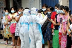 Pekerja Top Glove antre untuk tes COVID-19 di luar asrama mereka dengan pembatasan ketat di Klang, Malaysia 18 November 2020. 2020. (REUTERS/Lim Huey Teng/File Photo)