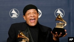 FILE - In this Sunday, Feb. 11, 2007, file photo, Al Jarreau poses with his awards for best pop instrumental performance for "Mornin'" and best traditional R&B vocal performance for "God Bless the Child" at the 49th Annual Grammy Awards in Los Angeles. Jarreau died in a Los Angeles hospital early Sunday, Feb. 12, 2017, according to his official Twitter account and website.