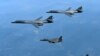 FILE - In this June 20, 2017, file photo provided by South Korean Defense Ministry, U.S. Air Force B-1B bombers, top, and second from top, and South Korean fighter jets F-15K fly over the Korean Peninsula, South Korea. A South Korean lawmaker said Oct. 10, 2017, that North Korean hackers may have stolen highly classified military documents that include U.S.-South Korean wartime "decapitation strike" plans against the North.