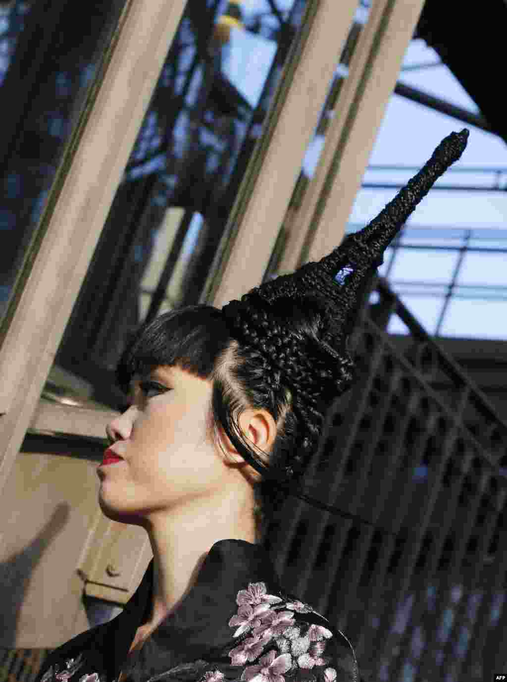 Vietnamese-born model and global fashion show organizer Jessica Minh Anh presents a creation during a fashion she organized, on a catwalk set up on the first floor of the Eiffel Tower in Paris.