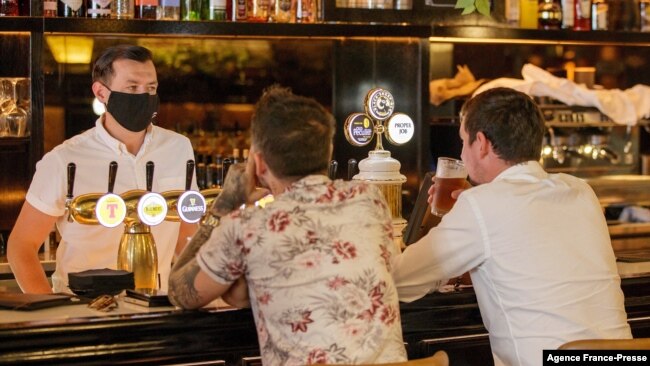 Customers sit at a bar on the first day of reopening in Auckland, New Zealand, on Dec. 3, 2021, as the country revamps its domestic COVID-19 response.