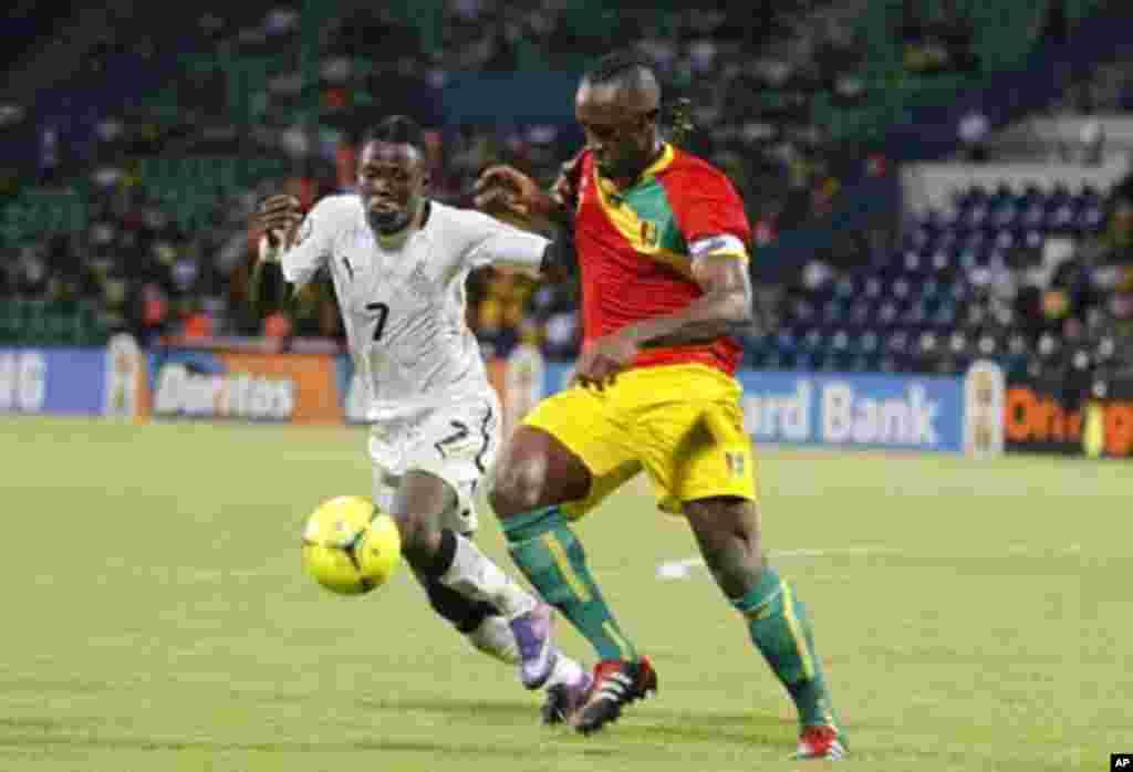 Guinea's Zayatte Kamil (R) challenges Inkoom Samuel of Ghana during their African Cup of Nations Group D soccer match at Franceville stadium February 1, 2012.
