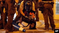 Police arrest a man as demonstrators march in response to a not guilty verdict in the trial of former St. Louis police officer Jason Stockley, Sunday, Sept. 17, 2017, in St. Louis. (AP Photo/Jeff Roberson)