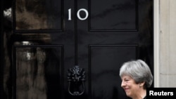 FILE - Britain's Prime Minister Theresa May walks out of 10 Downing Street in London, Jan. 30, 2018.