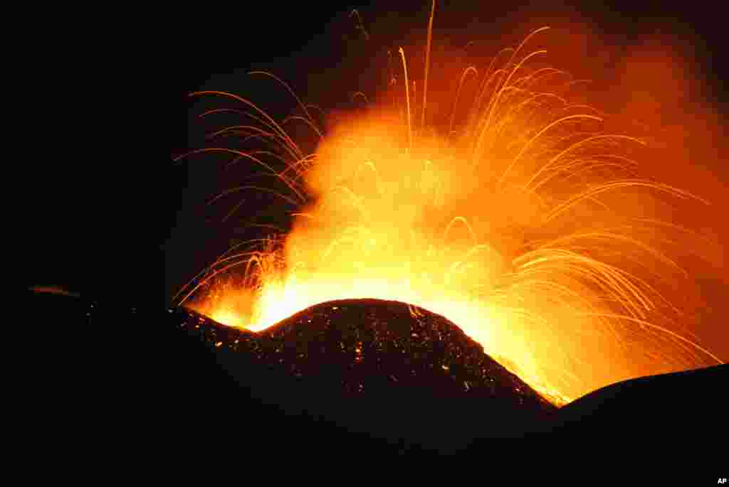 Lava spews from the South East Crater of Mt. Etna during an eruption, in Sicily, southern Italy.