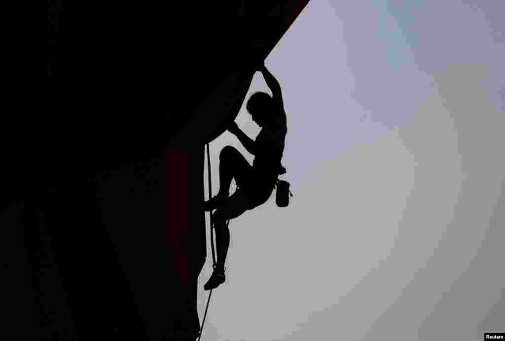 Sa Sol of South Korea is silhouetted as she competes in the women's combined lead climbing final at the 2018 Asian Games in Palembang, Indnesia.