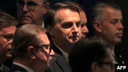 Brazil's President Jair Bolsonaro arrives at the inauguration ceremony of the new president of the Parliamentary Front of Agriculture (FPA), at the Clube Naval, in Brasilia, Jan. 19, 2019. 