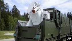 In this video grab provided by RU-RTR Russian television via AP television on March 1, 2018, a Russian military truck with a laser weapon mounted on it is shown at an undisclosed location in Russia. 